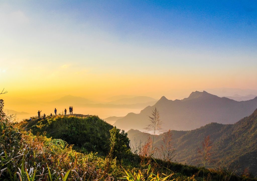 photo of people standing on top of mountain near grasses 733162.jpg